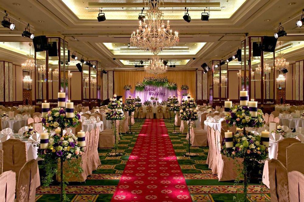 เอเวอร์กรีน เลาเรล โฮเต็ล ไทชุง Hotel ไถจง ภายนอก รูปภาพ The photo shows an elegantly decorated banquet hall set up for a wedding or formal event. The center aisle is lined with rows of elegantly draped chairs and features a bright red carpet. On either side of the aisle, there are beautifully arranged flo